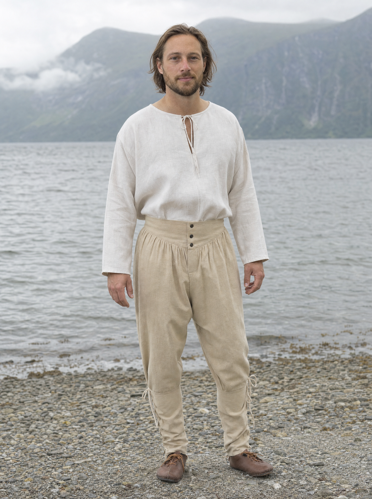 Man in a white shirt and off-white laced trousers with ankle ties outdoors