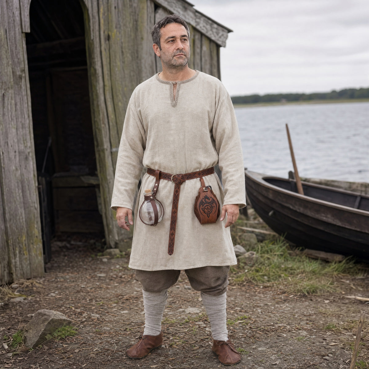 Brown knight belt with bottle holder and dragon pouch worn outdoors, full-length front view