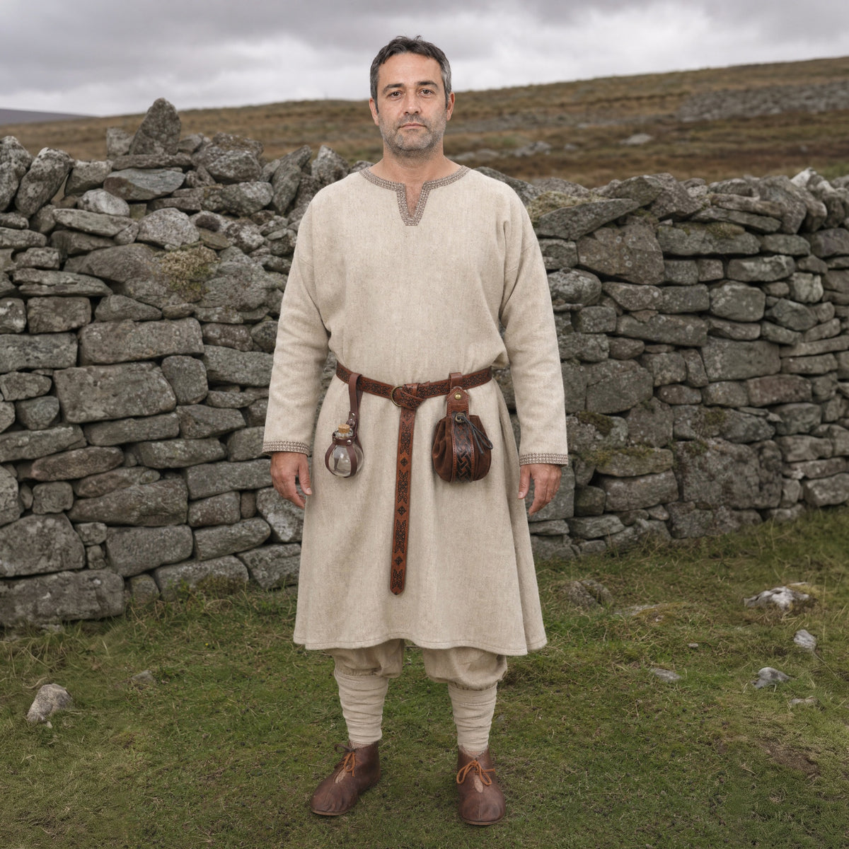 Brown knight belt with bottle holder and pouch worn outdoors, full-length front view