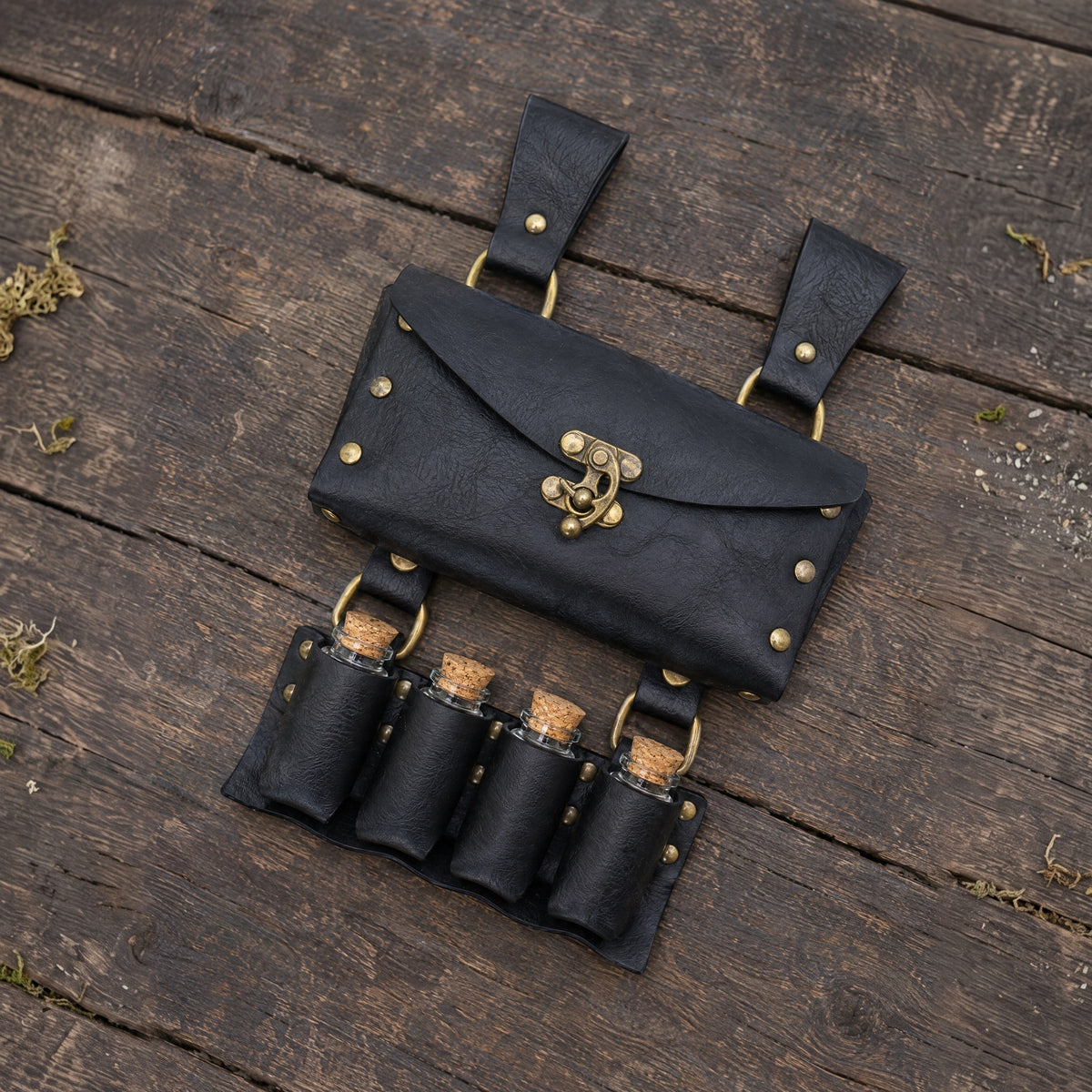 Black belt pouch with four potion vials on a rustic surface