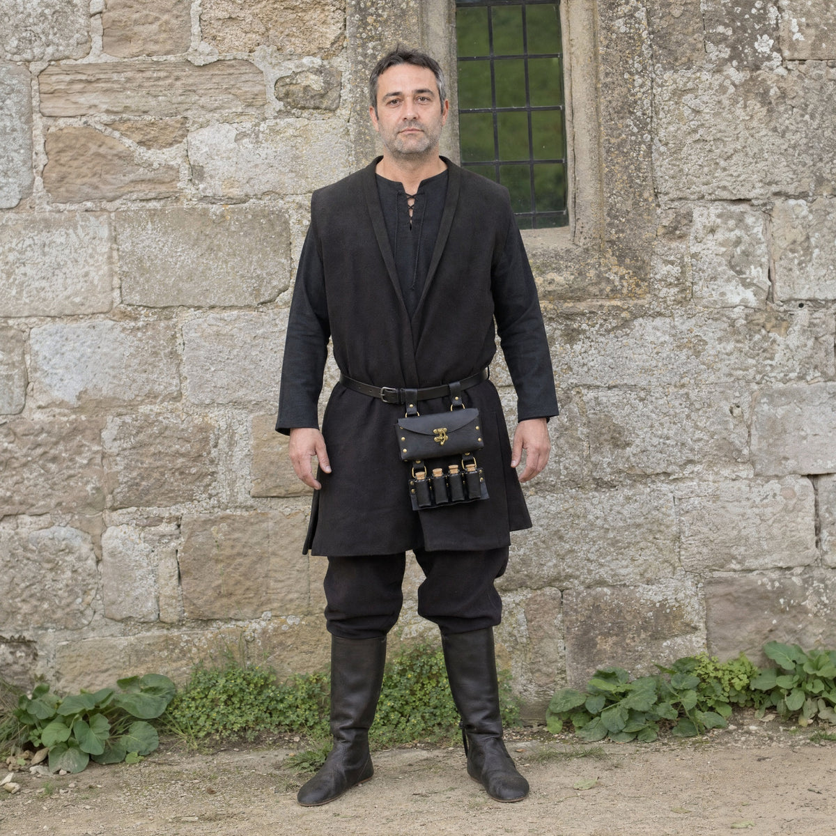 Black belt pouch with four potion vials worn outdoors, full-length front view