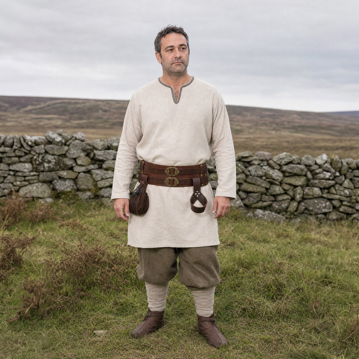 Brown wide Celtic belt with sword frog and pouch worn outdoors, full-length front view