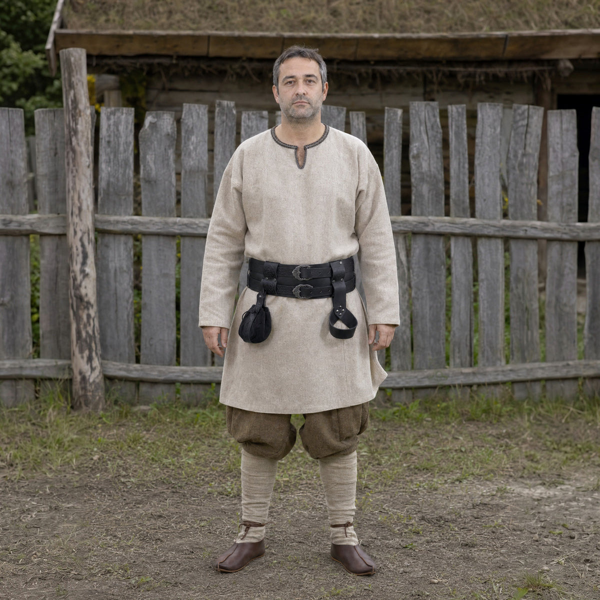 Black wide Celtic belt with sword frog and pouch worn outdoors, full-length front view