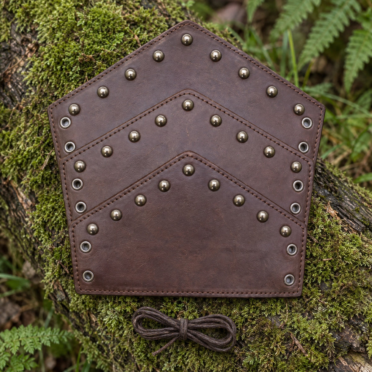 Brown chevron stud bracer on a rustic surface