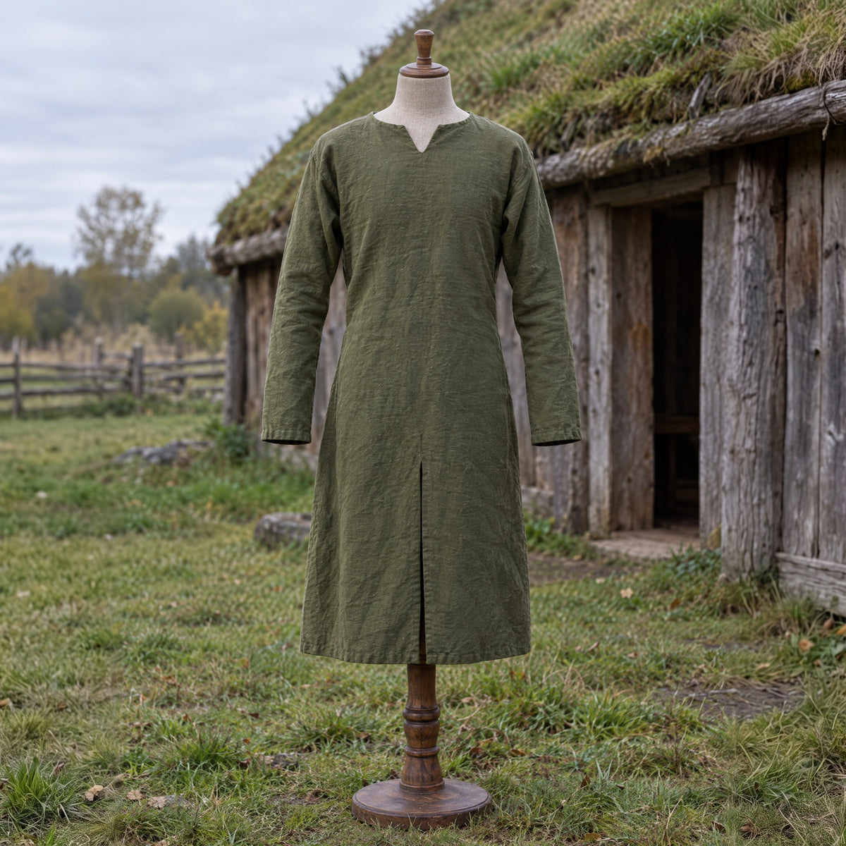 Green cotton viking tunic on a dress form outdoors
