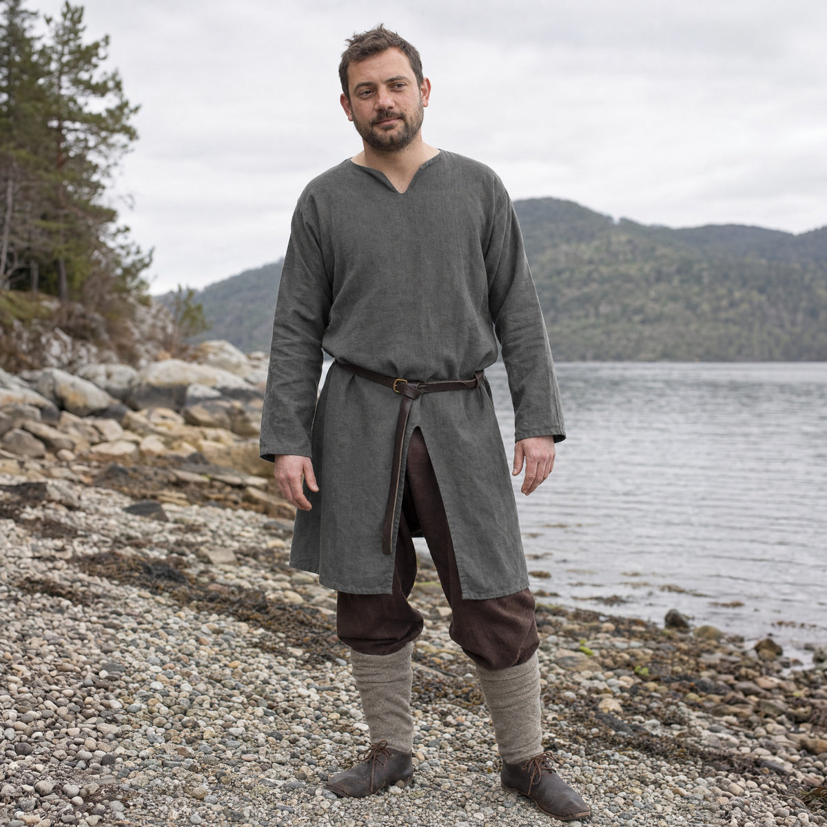 Grey cotton Viking tunic worn by a man outdoors, full-length front view