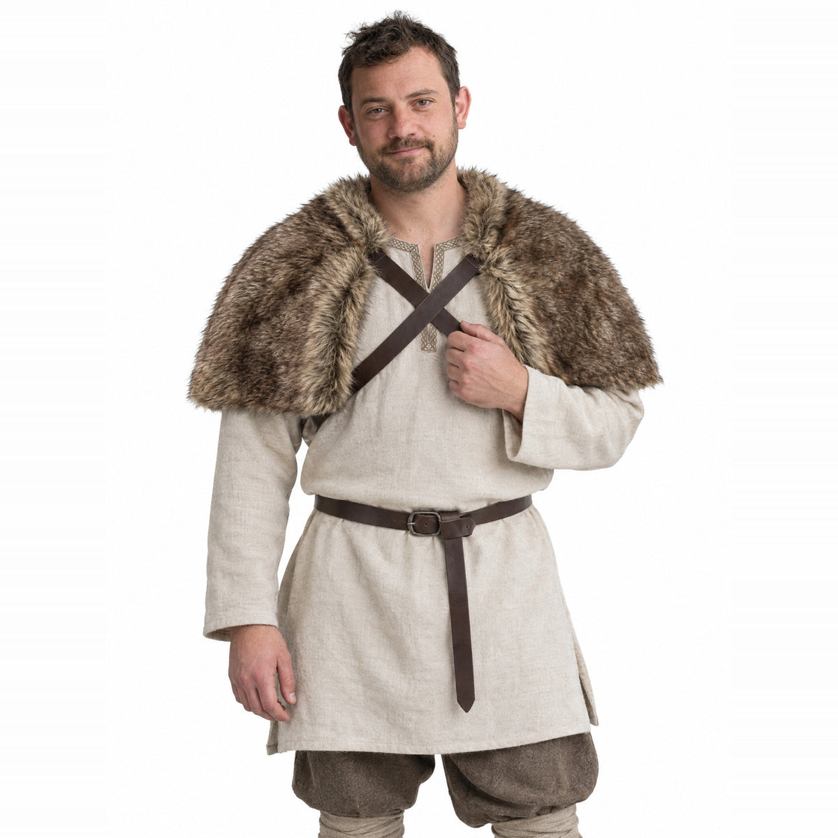 Brown faux fur shoulder cape with cross straps worn by a model on a white background