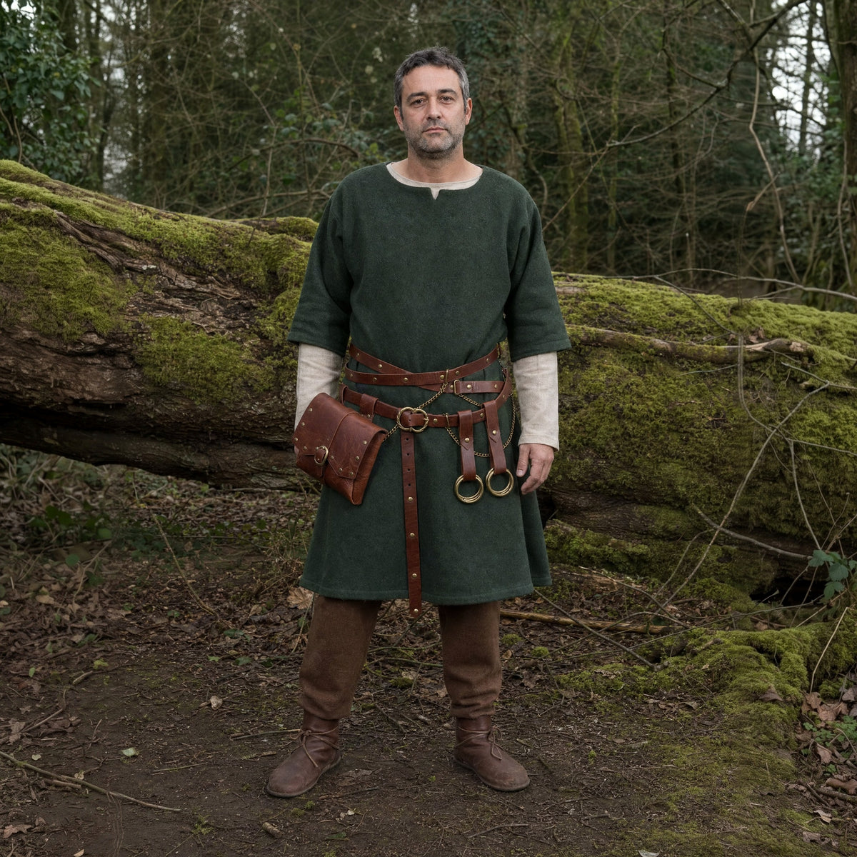 Brown crossed belt with flap pouch worn outdoors, full-length front view