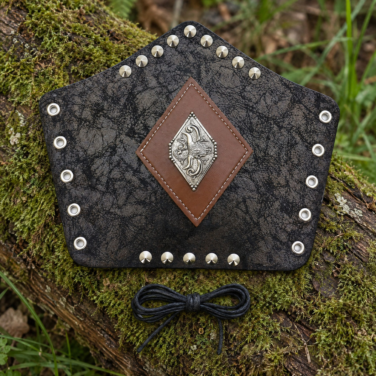 Black diamond plate bracer on a rustic surface