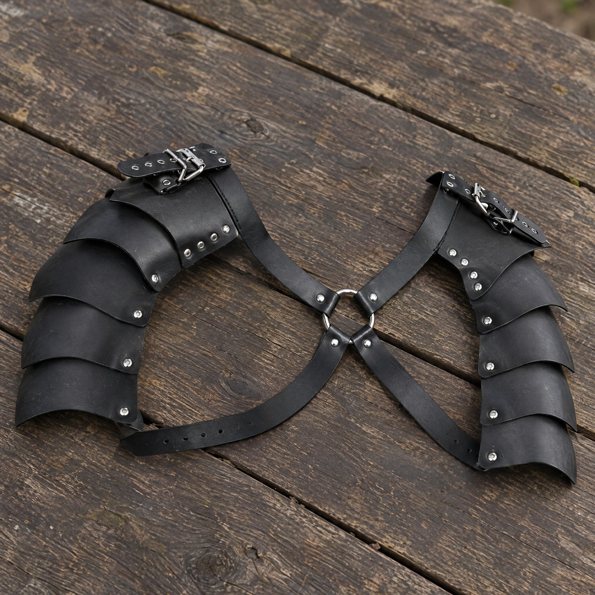 Black double shoulder armour on a rustic surface