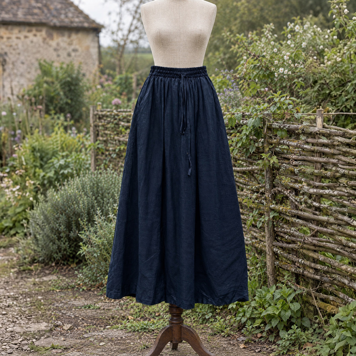 Navy drawstring ramie skirt on a dress form outdoors