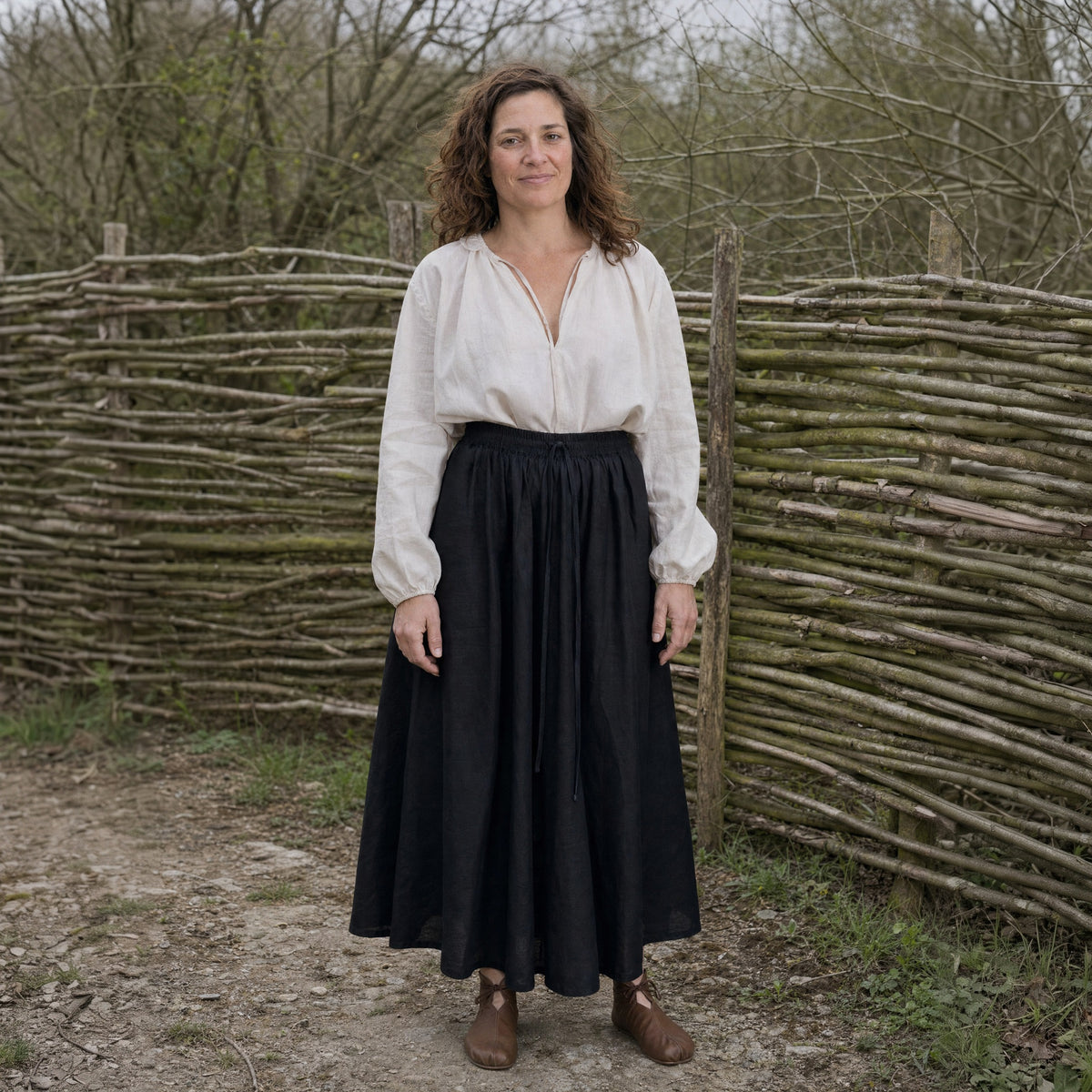 Black drawstring ramie skirt worn by a woman outdoors, full-length front view
