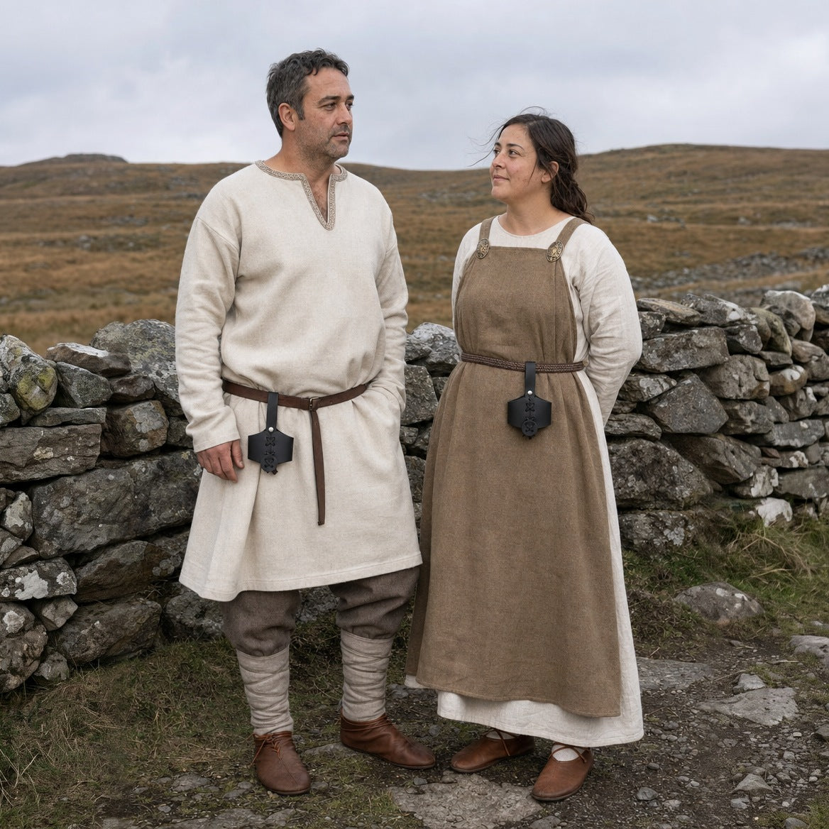 Black laced drinking horn holders worn by a man and a woman outdoors