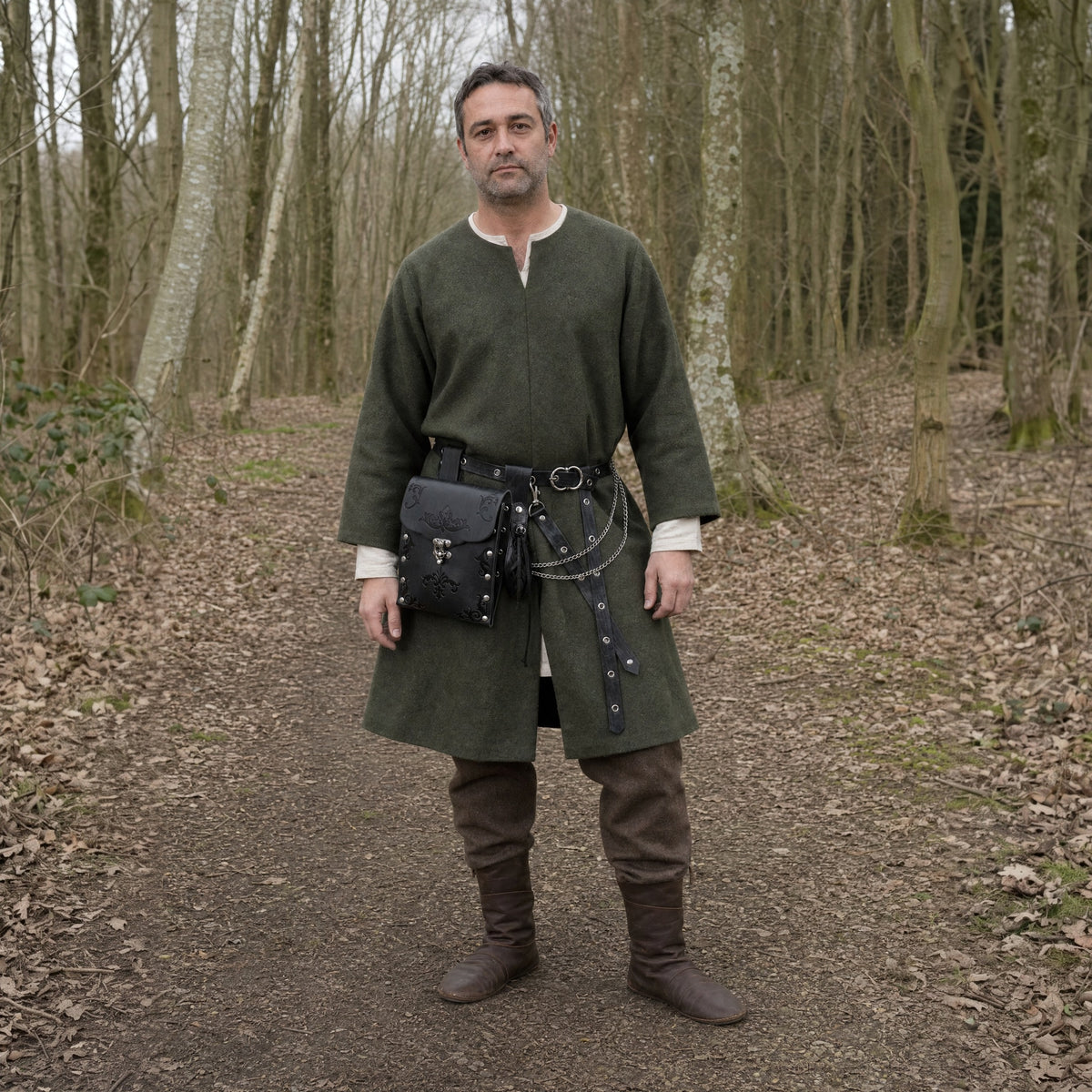 Black embossed waist bag belt with pouch worn outdoors, full-length front view