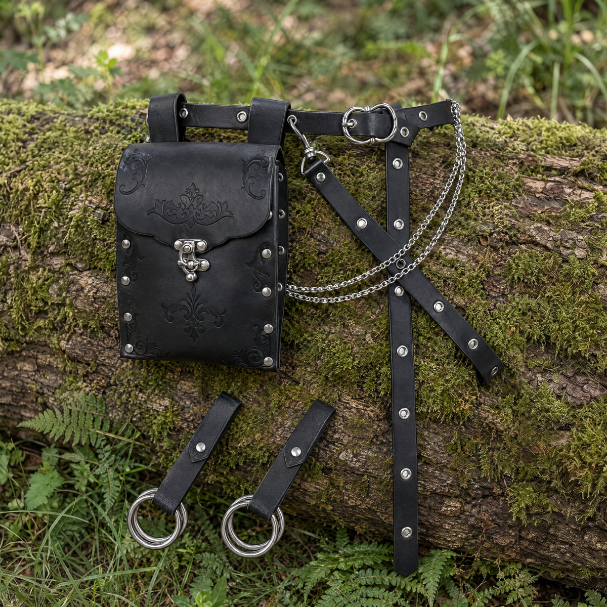 Black embossed waist bag belt with ring hangers on a rustic surface