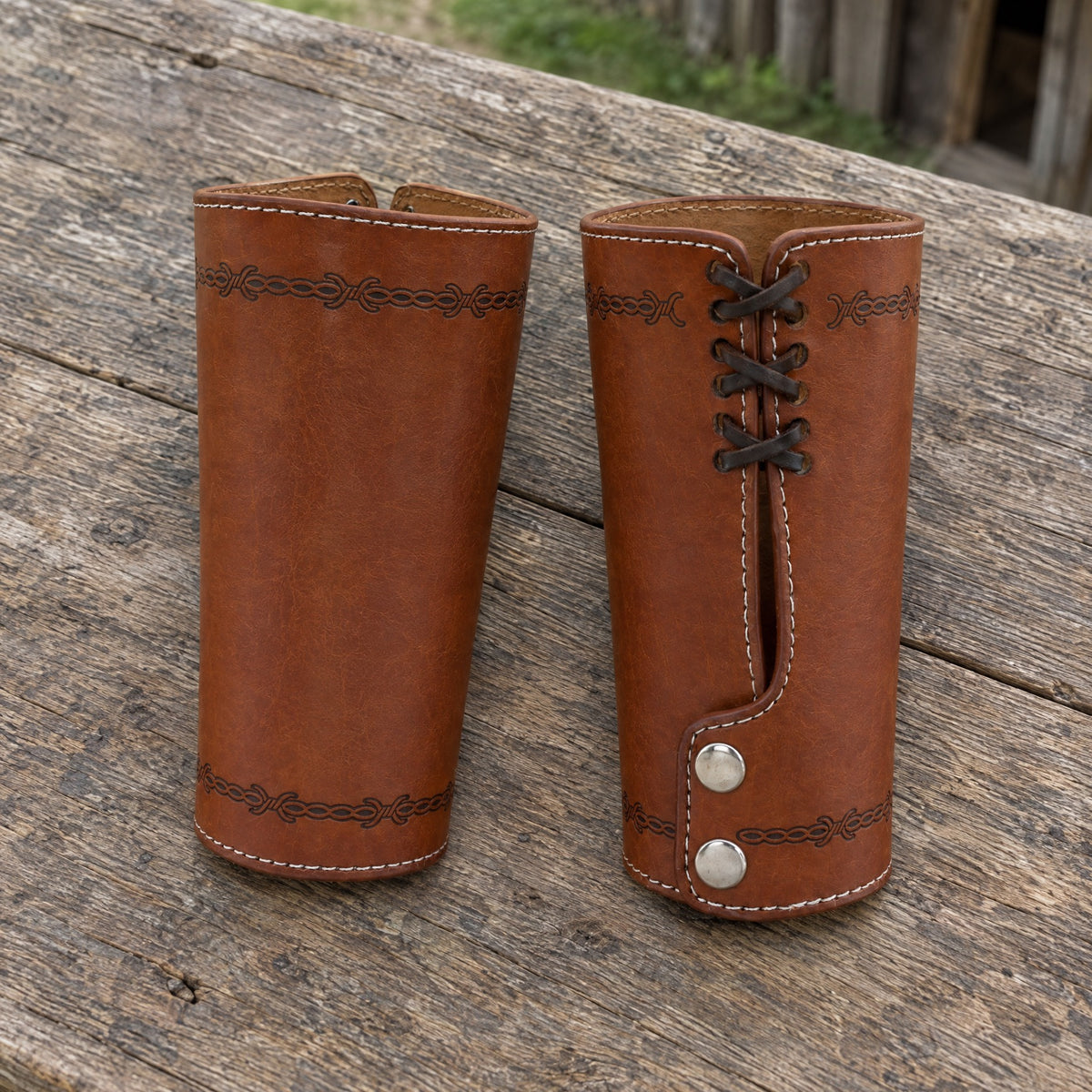 Coffee embossed cuff bracers on a rustic surface