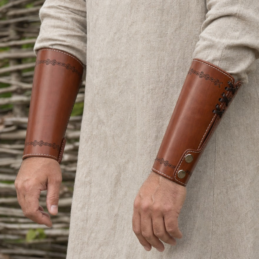 Embossed cuff bracer on a forearm, showing the 16 cm length above the wrist