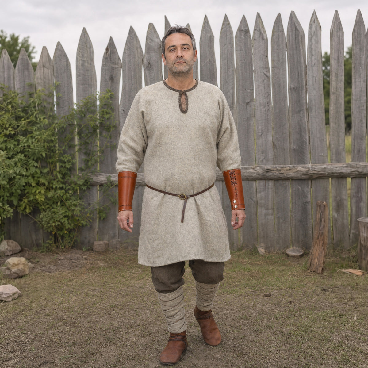 Brown embossed cuff bracers worn outdoors, full-length front view