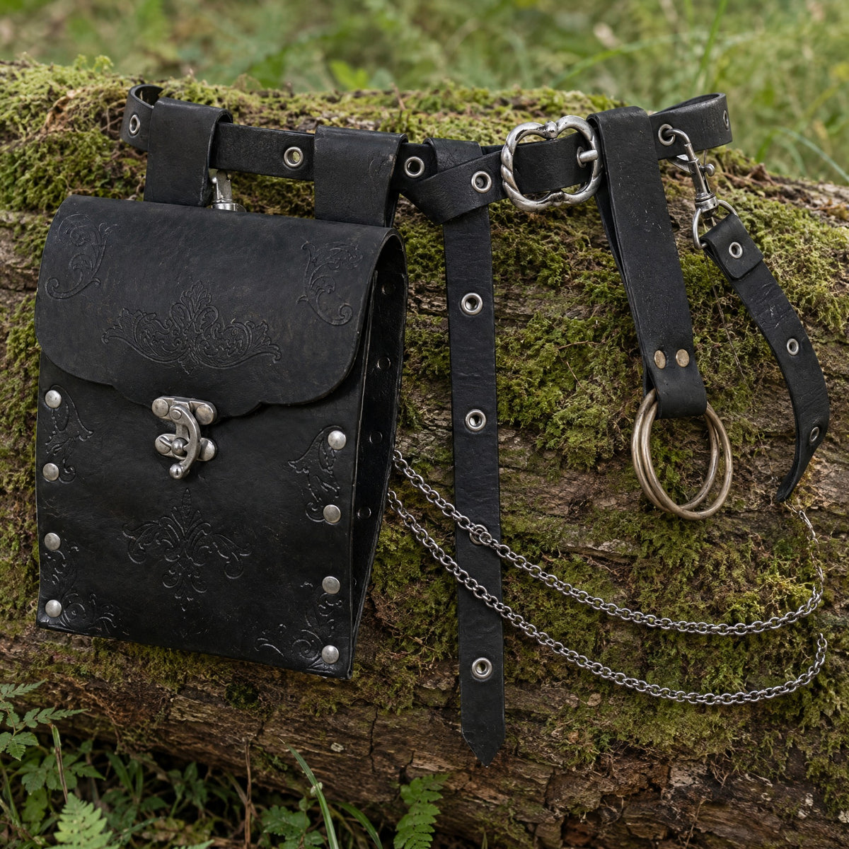 Black embossed waist bag with chain belt on a rustic surface