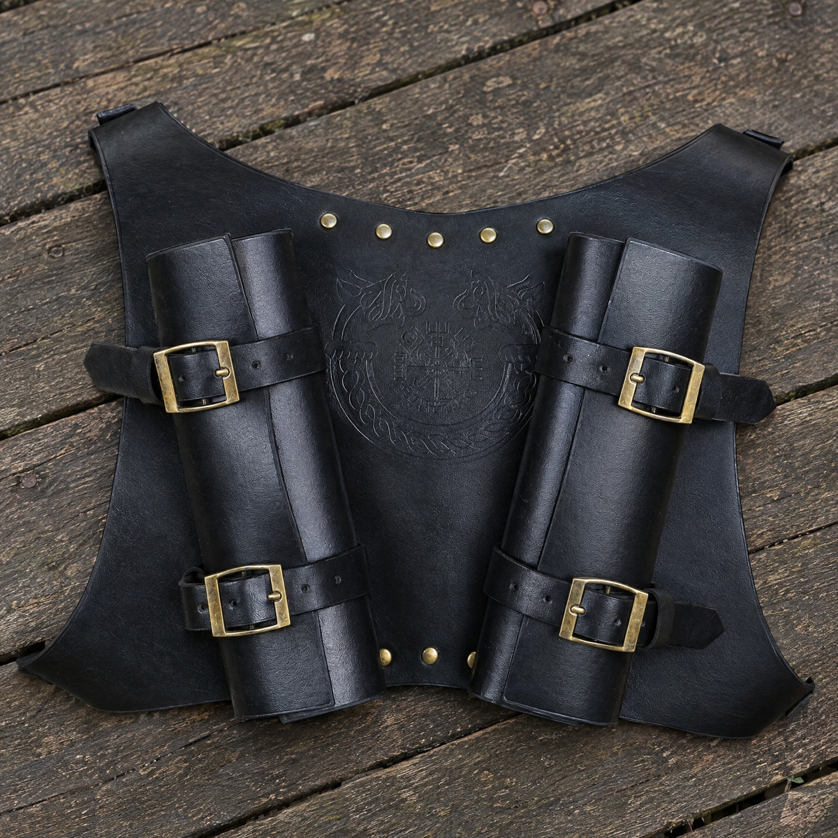 Black faux leather double sword harness on a rustic surface