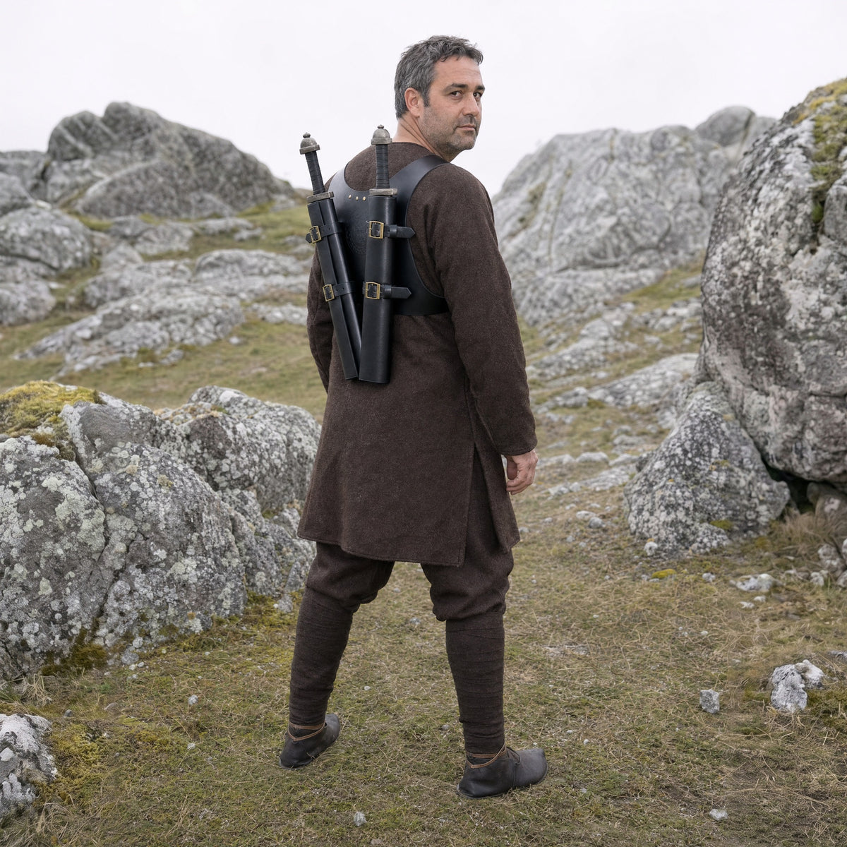 Black double sword harness worn with two swords outdoors, full-length front view
