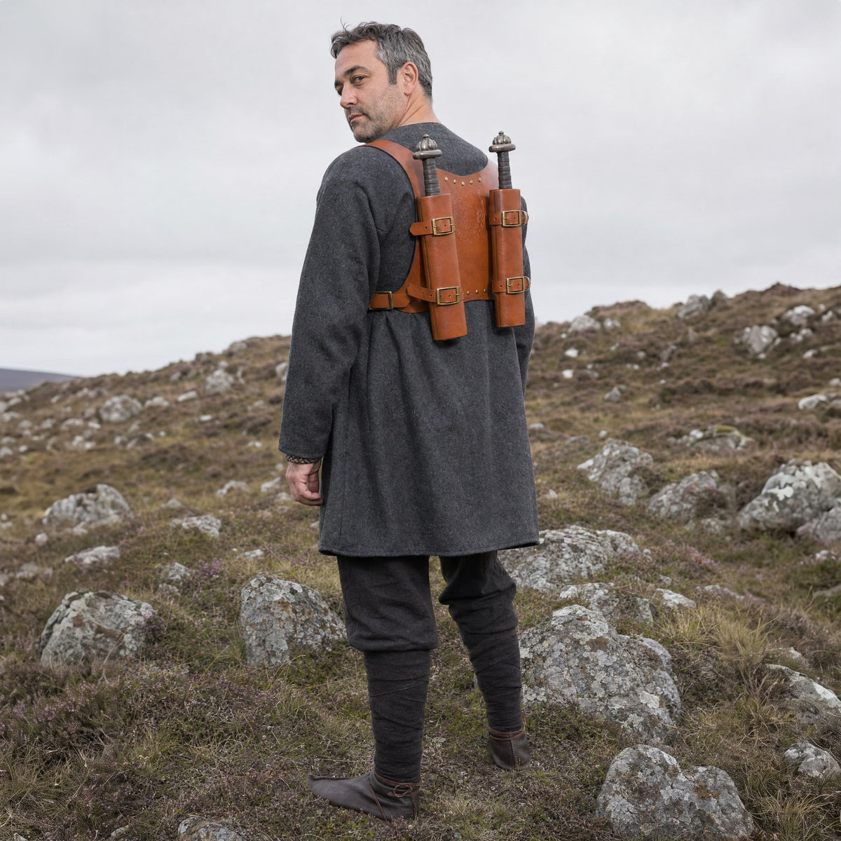 Brown double sword harness worn with two swords outdoors, full-length front view