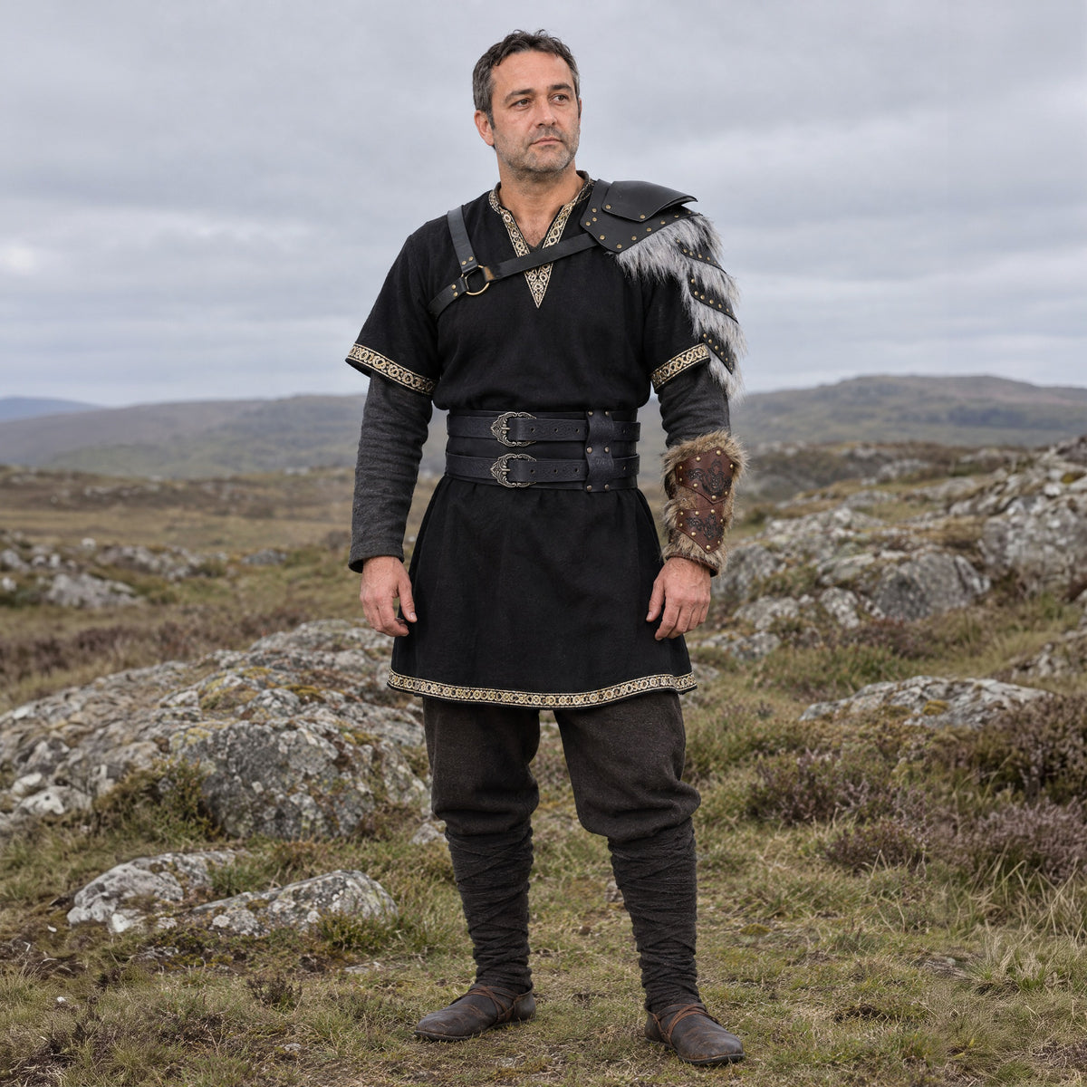 Buckled fur-trim pauldron in a complete dark warrior outfit, worn by a man outdoors