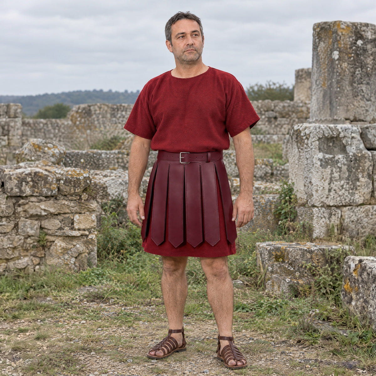 Wine Red faux leather Roman strip skirt worn over a tunic outdoors, full-length front view