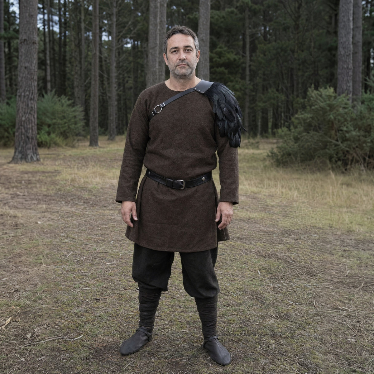 Black feathered single pauldron worn outdoors, full-length front view