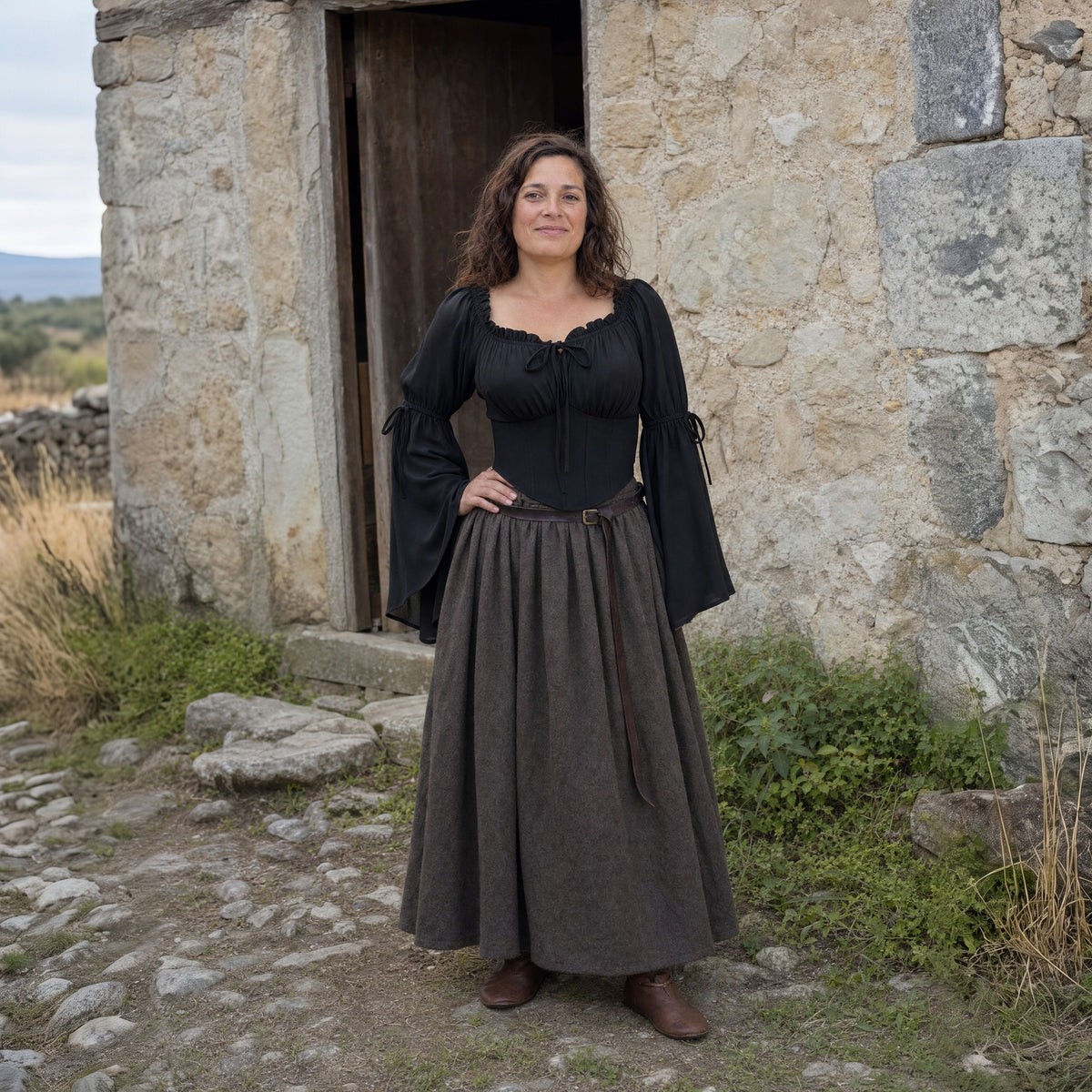 Black flared-sleeve Renaissance blouse worn by a woman outdoors, full-length front view