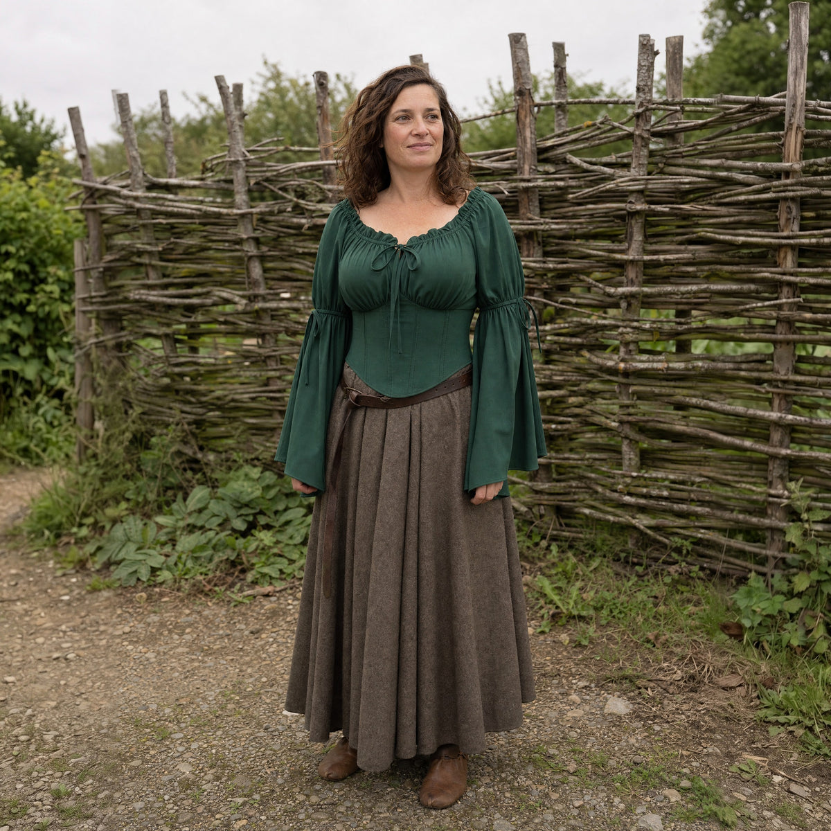 Green flared-sleeve Renaissance blouse worn by a woman outdoors, full-length front view