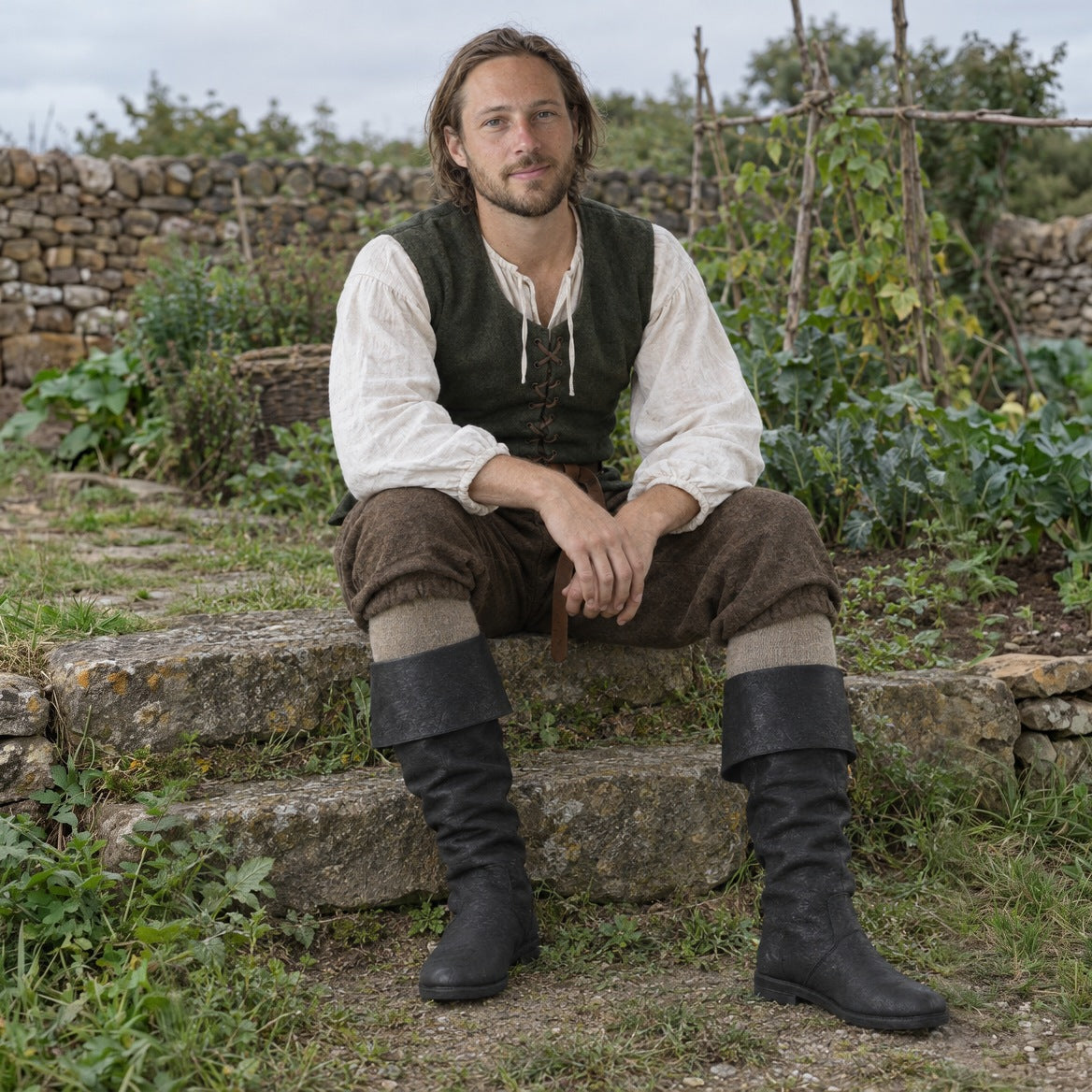 Fold-over cuff renaissance boots styled with knee breeches, a linen shirt and a laced jerkin