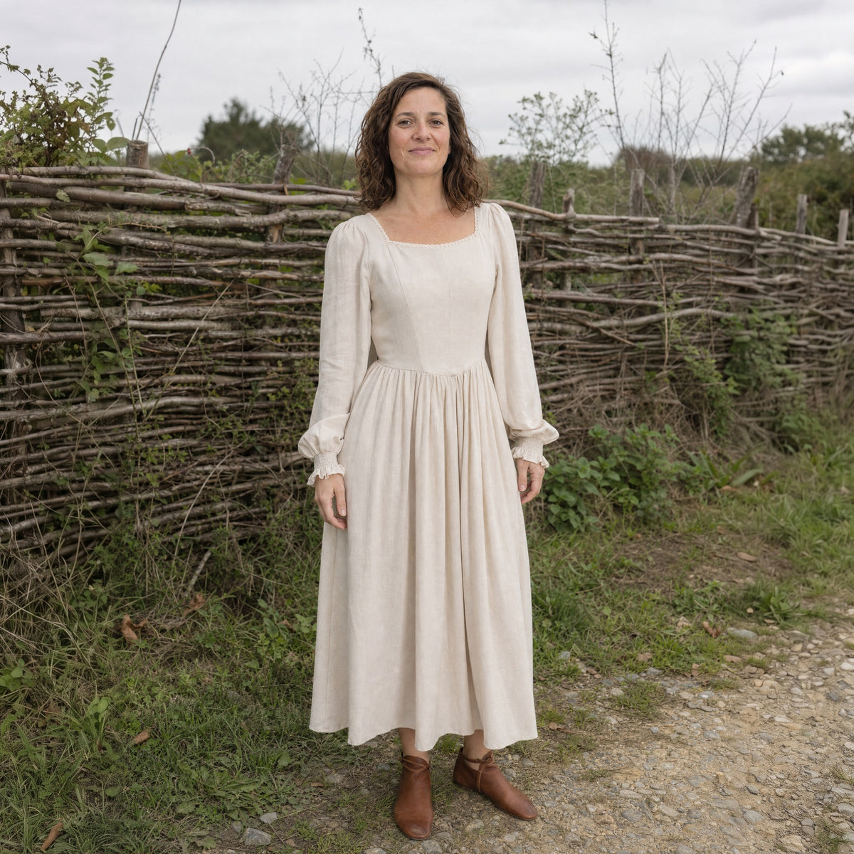 Full-skirt folk dress worn outdoors, full-length front view