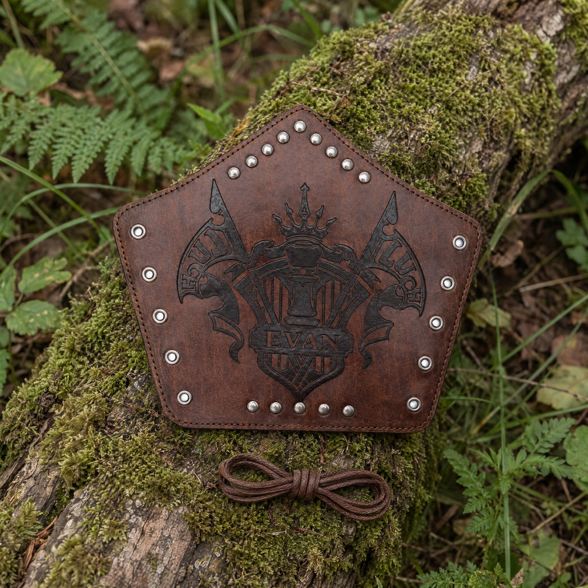 Brown heraldic banner bracer on a rustic surface