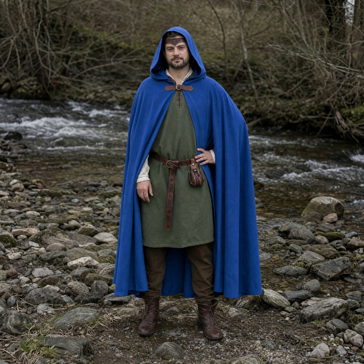 Blue hooded cloak with belt and pouch worn outdoors, full-length front view