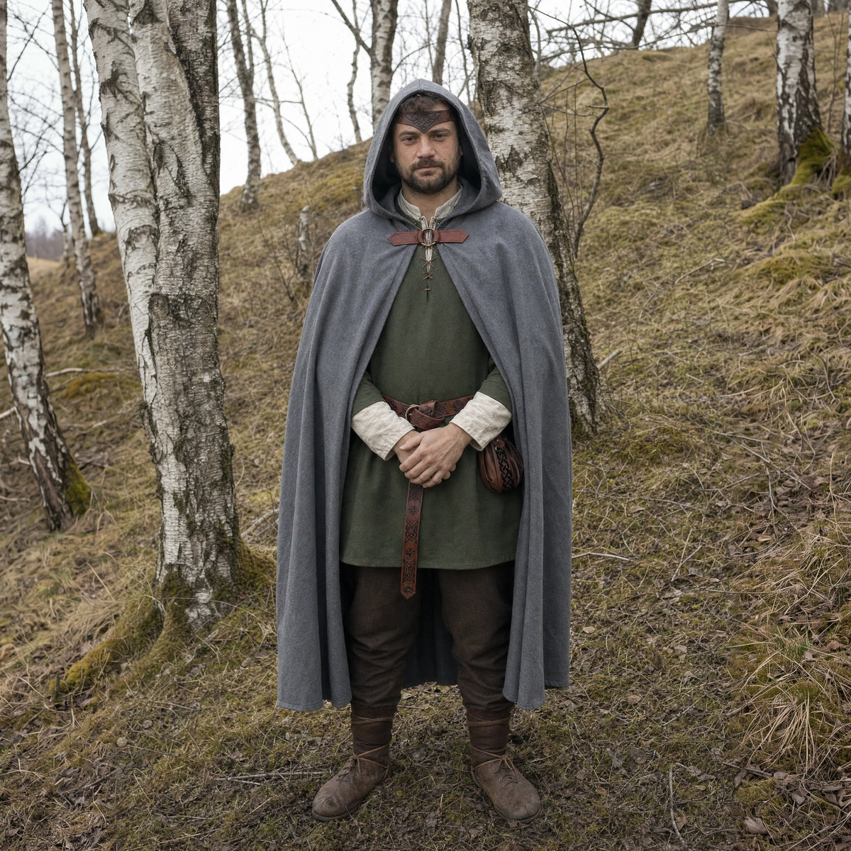 Grey hooded cloak with belt and pouch worn outdoors, full-length front view