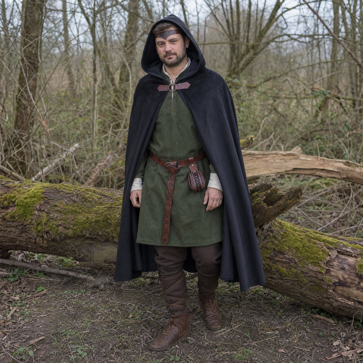 Black hooded cloak with belt and pouch worn outdoors, full-length front view