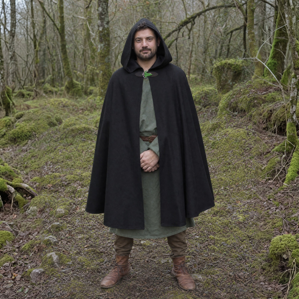Black hooded cloak with leaf brooch worn outdoors, full-length front view