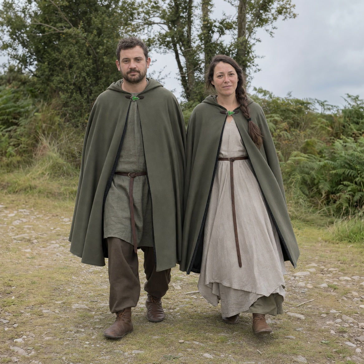 Hooded cloak with leaf brooch styled over a tunic and boots
