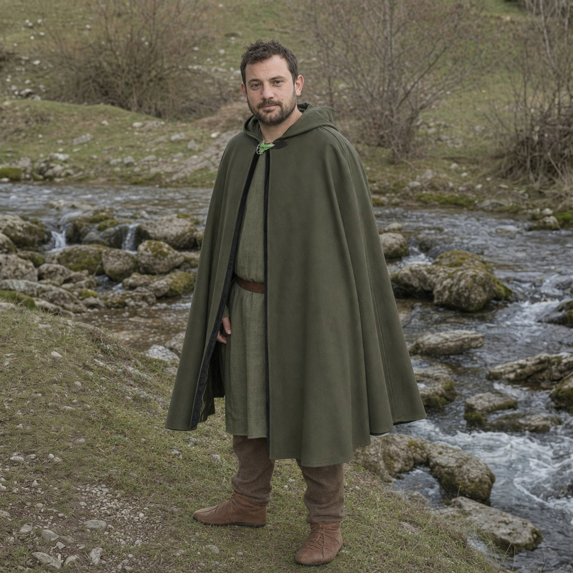 Green hooded cloak, three-quarter view showing the leaf brooch