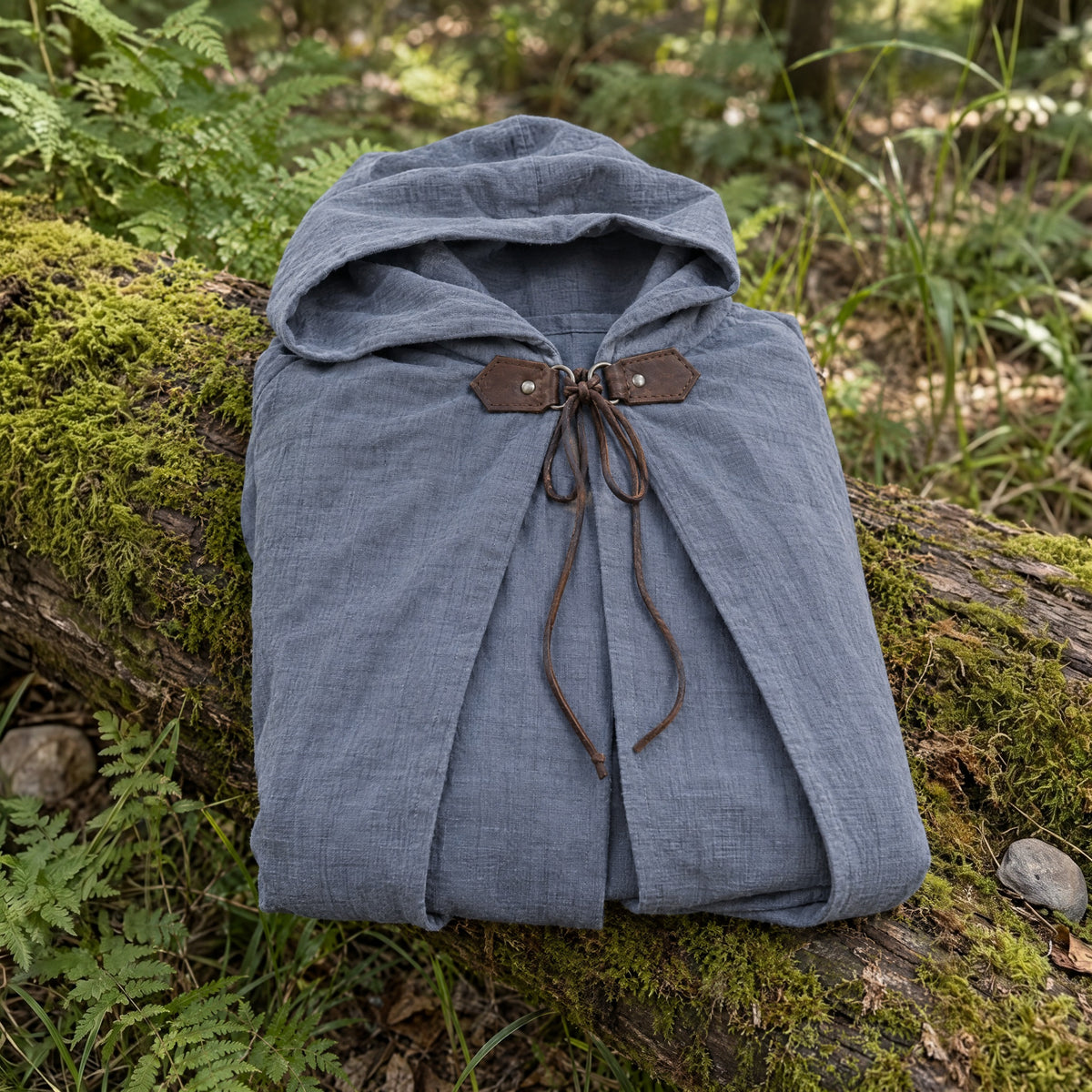 Grey hooded ranger cloak on a rustic surface