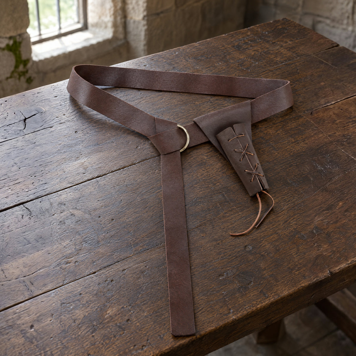 Brown knight belt with sword frog on a rustic surface