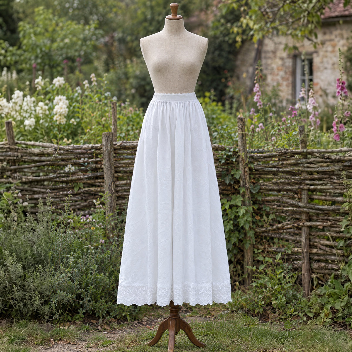 White lace-hem cotton petticoat on a dress form outdoors
