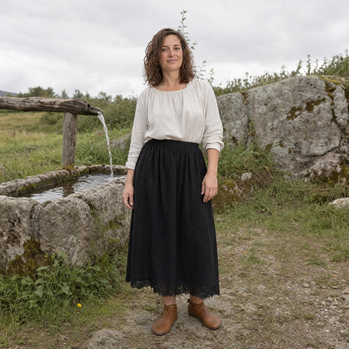 Black lace-hem cotton petticoat worn by a woman outdoors, full-length front view