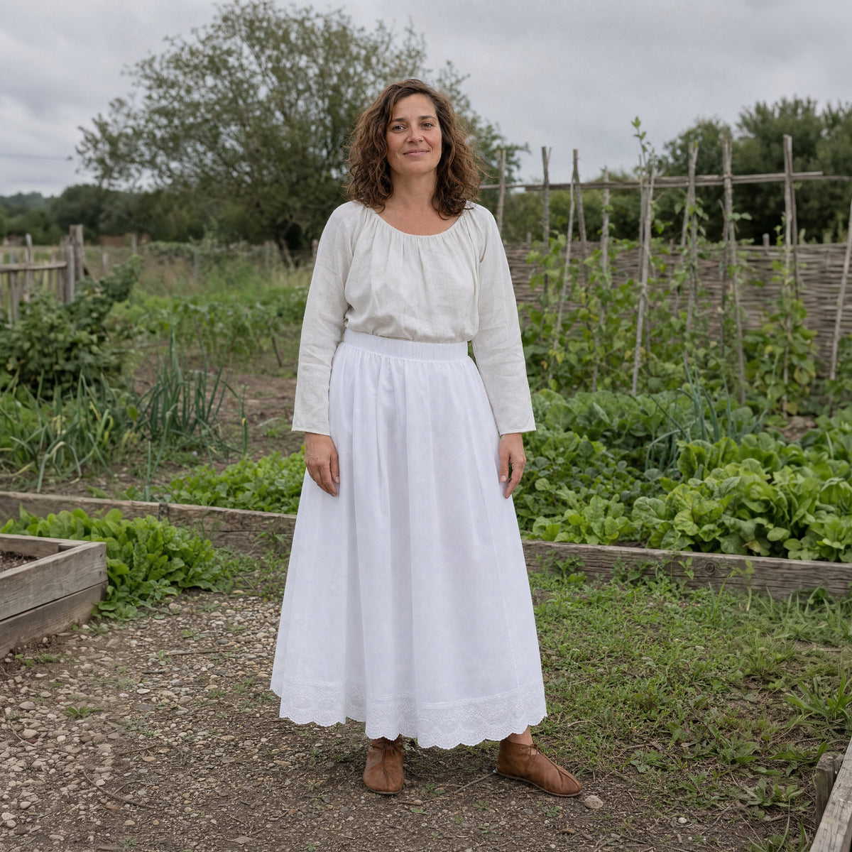 White lace-hem cotton petticoat worn by a woman outdoors, full-length front view