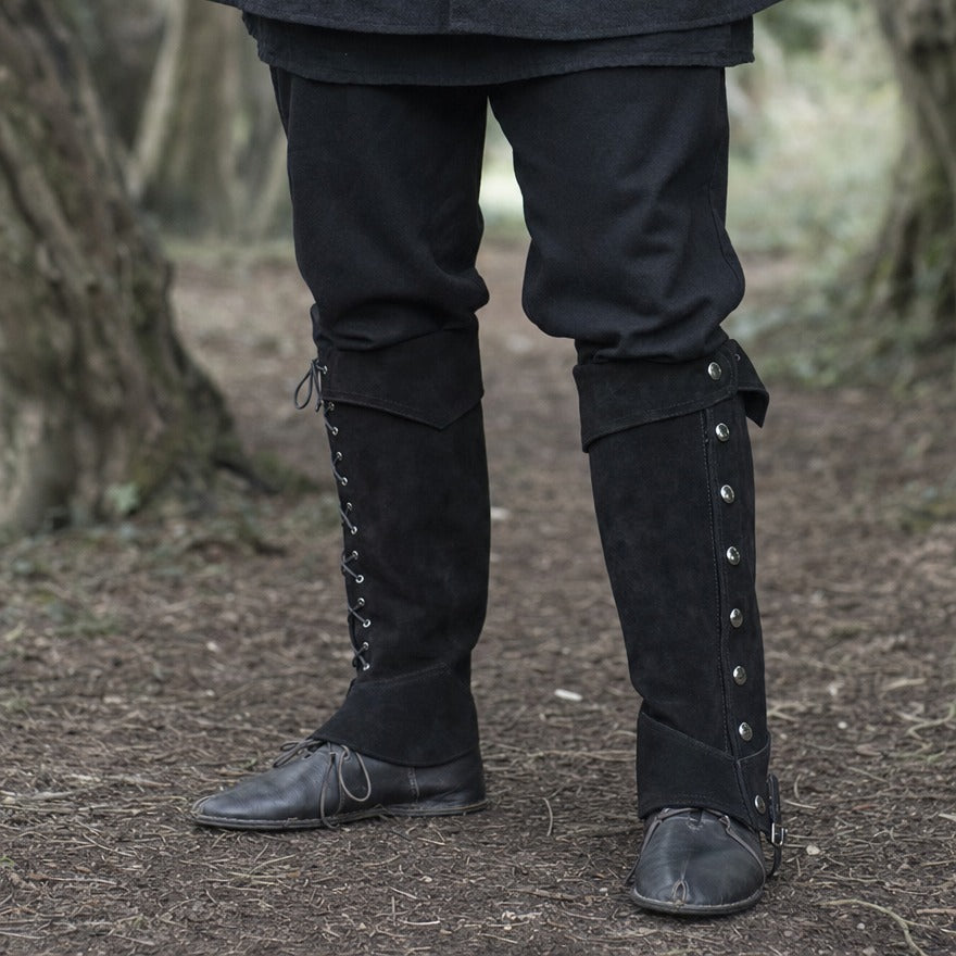 Lace-up studded gaiters on a wearer, showing how far up the leg they reach