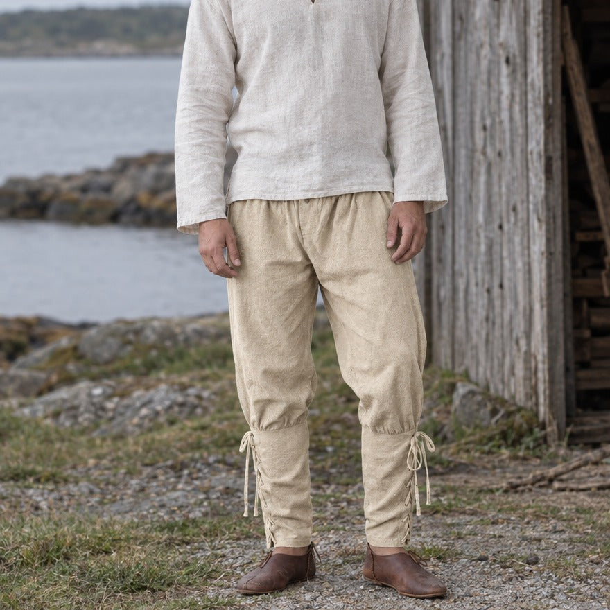 Laced trousers on a wearer, showing the narrow lower leg and ankle ties