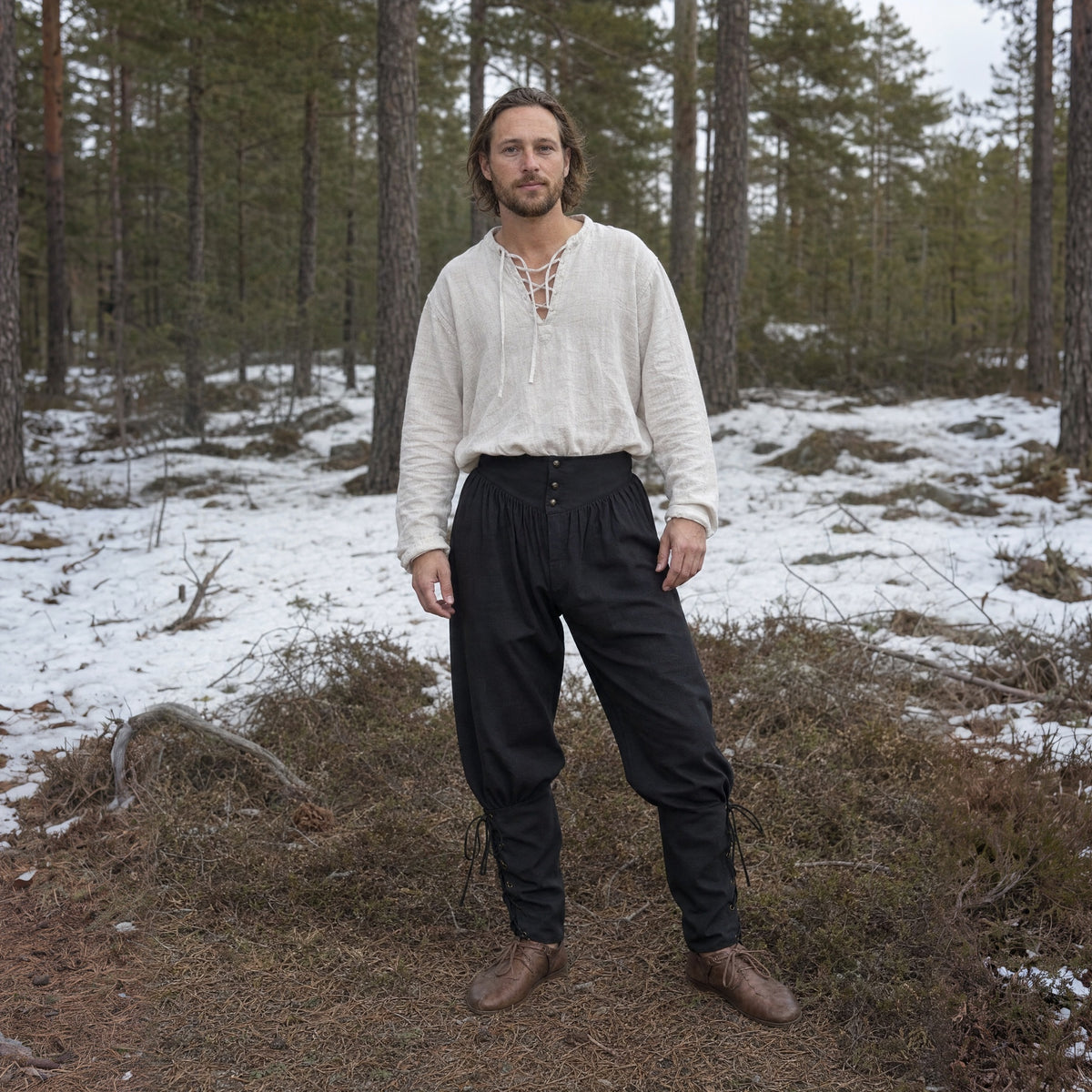 Black laced trousers with ankle ties worn outdoors, full-length front view