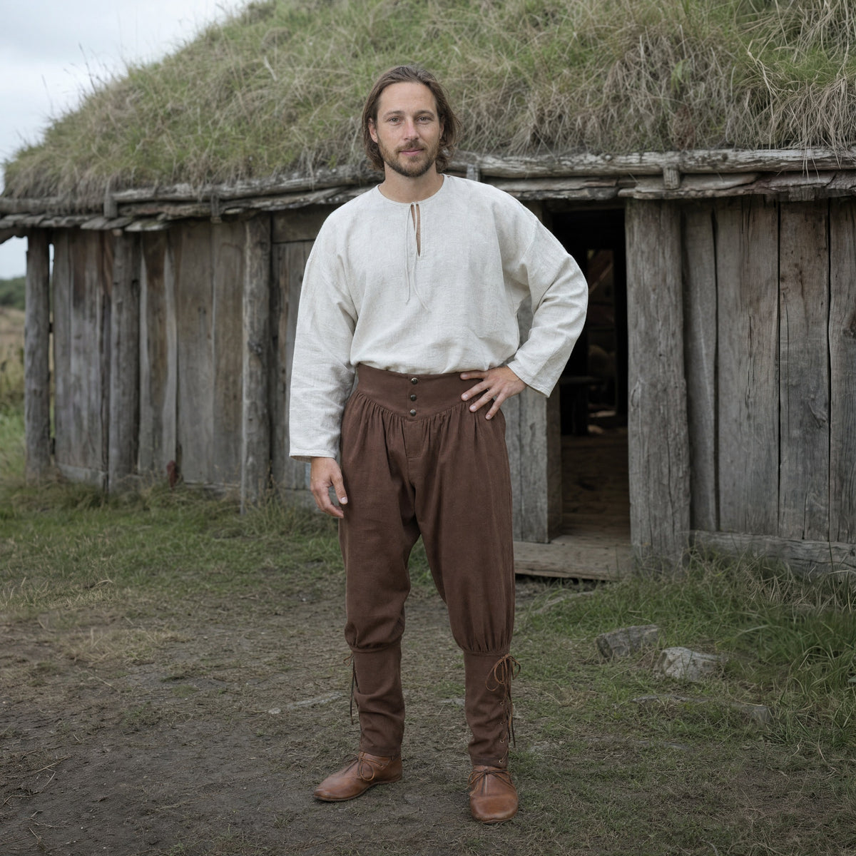 Brown laced trousers with ankle ties worn outdoors, full-length front view
