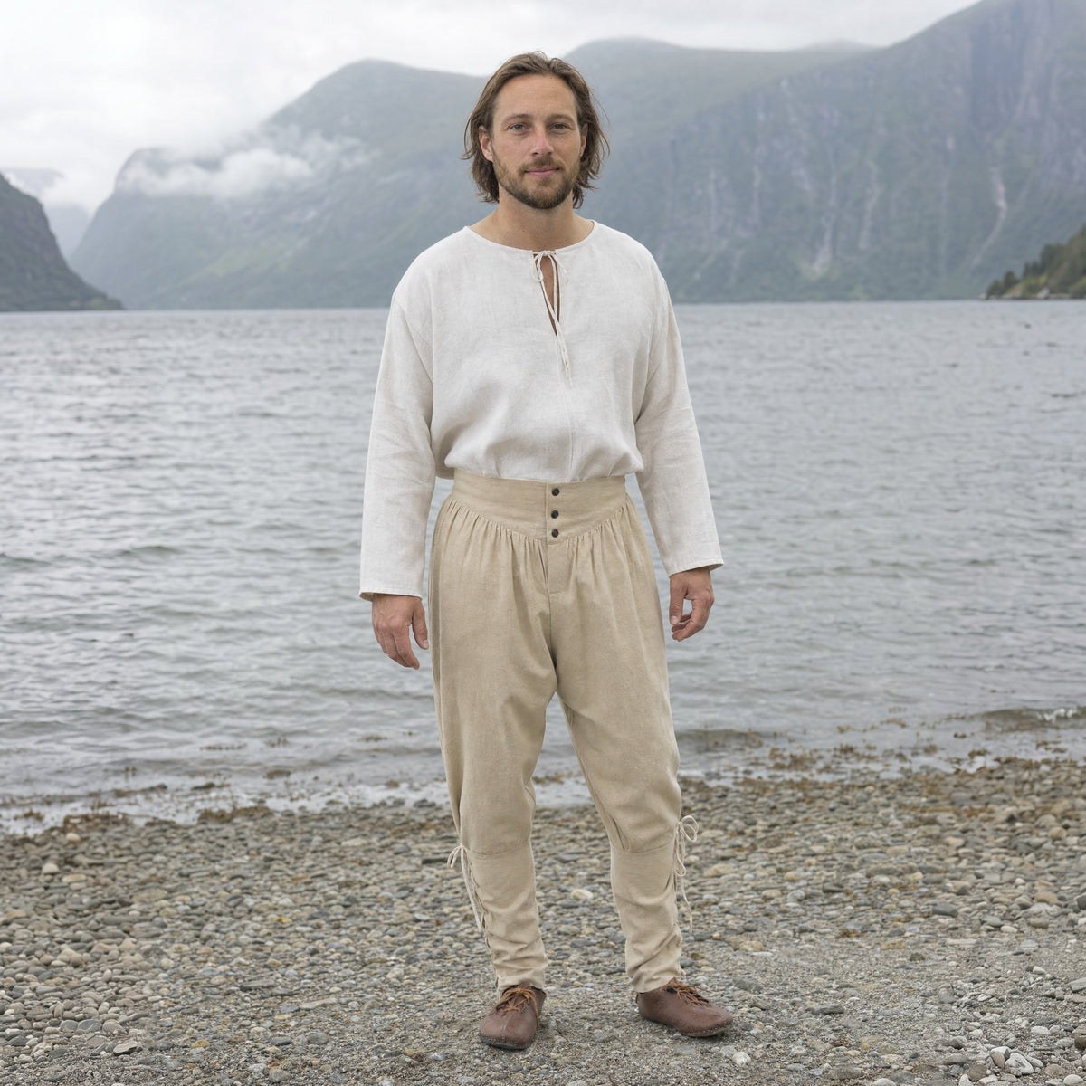 Off-White laced trousers with ankle ties worn outdoors, full-length front view